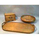 A blonde wood two handled tray with finger grips, 59cm together with a turned wood bowl, 36.5cm