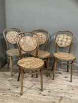 A set of four bentwood and begere caned dining chairs