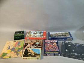 A collection of vintage and unopened jigsaw puzzles including The World's Most Difficult Jigsaw