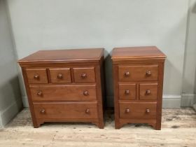 Two cherry wood bedside chests, one having three small drawers across and two further drawers, the