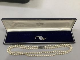 A cultured pearl necklace approx 5.5mm size strung in two rows fastened with a silver marcasite