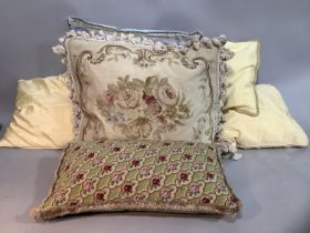 Two needlework and velvet cushions together with others