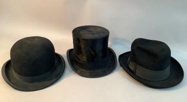 A black bowler hat by Moores and another by G A Dunn, London together with a black top hat with