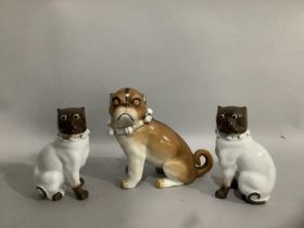 Three 19th century continental Dresden style porcelain figures of pugs having collars with bells,