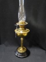 An Art Nouveau Period Circular Based Brass Column Oil Lamp