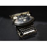 A Cased Vintage "The Empire" Portable Typewriter