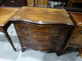 A Serpentine Fronted Mahogany Four Drawer Chest With Dressing Slide