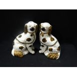 A Pair Of Staffordshire Pottery Lustre Decorated Seated Dogs With Separate Front Legs, 9" High