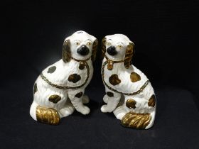 A Pair Of Staffordshire Pottery Lustre Decorated Seated Dogs With Separate Front Legs, 9" High