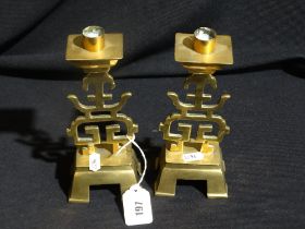 A Pair Of Chinese Brass Four Footed Candle Holders