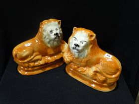 A Pair Of Staffordshire Pottery Seated Lions With Inset Glass Eyes