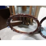 A Carved Wooden Framed Oval Wall Mirror