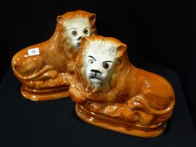 A Pair Of Staffordshire Pottery Seated Lions With Inset Glass Eyes