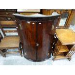 An Early 19thc Mahogany Two Door Bow Front Hanging Corner Cupboard