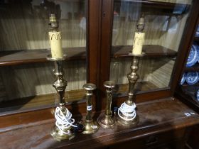 A Pair Of Brass Table Lamps, Together With A Pair Of Arts & Crafts Brass Candle Holders