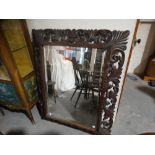 An Early 20thc Bevelled Wall Mirror Within An Ornate Carved Oak Frame, Mirror Size 32" X 24"
