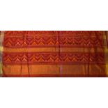 India - Patola with Gold Border handmade in red with a decorative pattern, a modern cloth in an