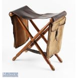 A rare leather and ash folding fishing seat with canvas and leather saddle bags, and brass loops for