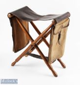 A rare leather and ash folding fishing seat with canvas and leather saddle bags, and brass loops for