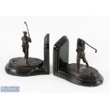 Pair of early bronze golfing bookends - each with a Victorian golfing figure on naturalistic oval
