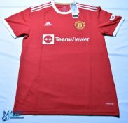 Three reproduction Manchester United FC football shirts - 2021/22 Home & Away, 2006-2008 Away. All
