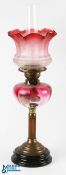 A Fine Cranberry Glass Oil Lamp & Transfer Etched Shade, complete with chimney, brass fittings