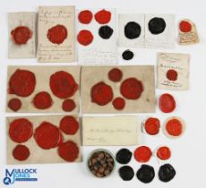A large collection of wax seals, the red and black seals depicting various crests, predominately