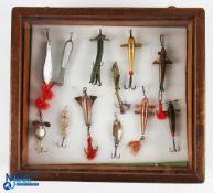 An interesting collection of artificial baits in mahogany glass fronted wall display case, made up