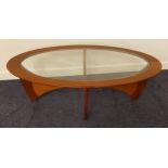 G PLAN TEAK ASTRO OCCASIONAL TABLE with an oval inset glass trop, standing on shaped supports, 122cm