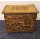 BRASS EMBOSSED COAL BIN with a lift up lid decorated with tavern scenes, on casters, 41.5cm high