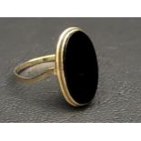 BLACK AGATE SET DRESS RING in unmarked gold, damage to shank