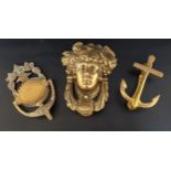 THREE BRASS DOOR KNOCKERS comprising Athena, 19cm high, an anchor, 14cm high and a decorative urn,