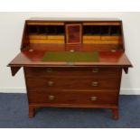 GEORGE III MAHOGANY BUREAU with a fall flap opening to reveal an inset baize lining and an