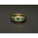 GRADUATED EMERALD AND DIAMOND CLUSTER RING the three round cut emeralds totalling approximately 0.