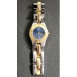 LADIES BAUME & MERCIER WRISTWATCH the blue dial with gold coloured bezel set with Arabic numerals,