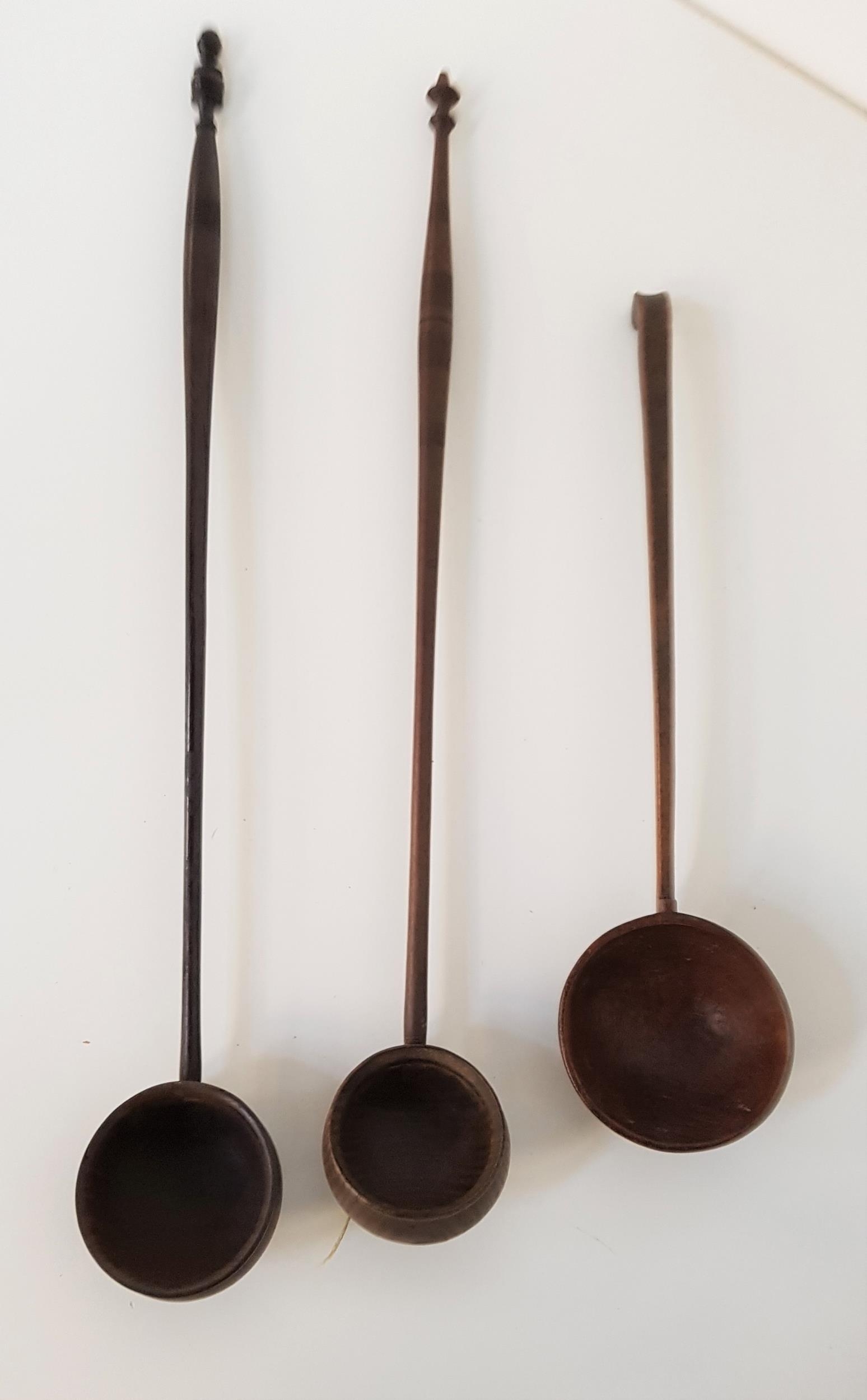LATE 18th CENTURY TREEN LADLE with a shaped handle and deep circular bowl, 29cm long, together