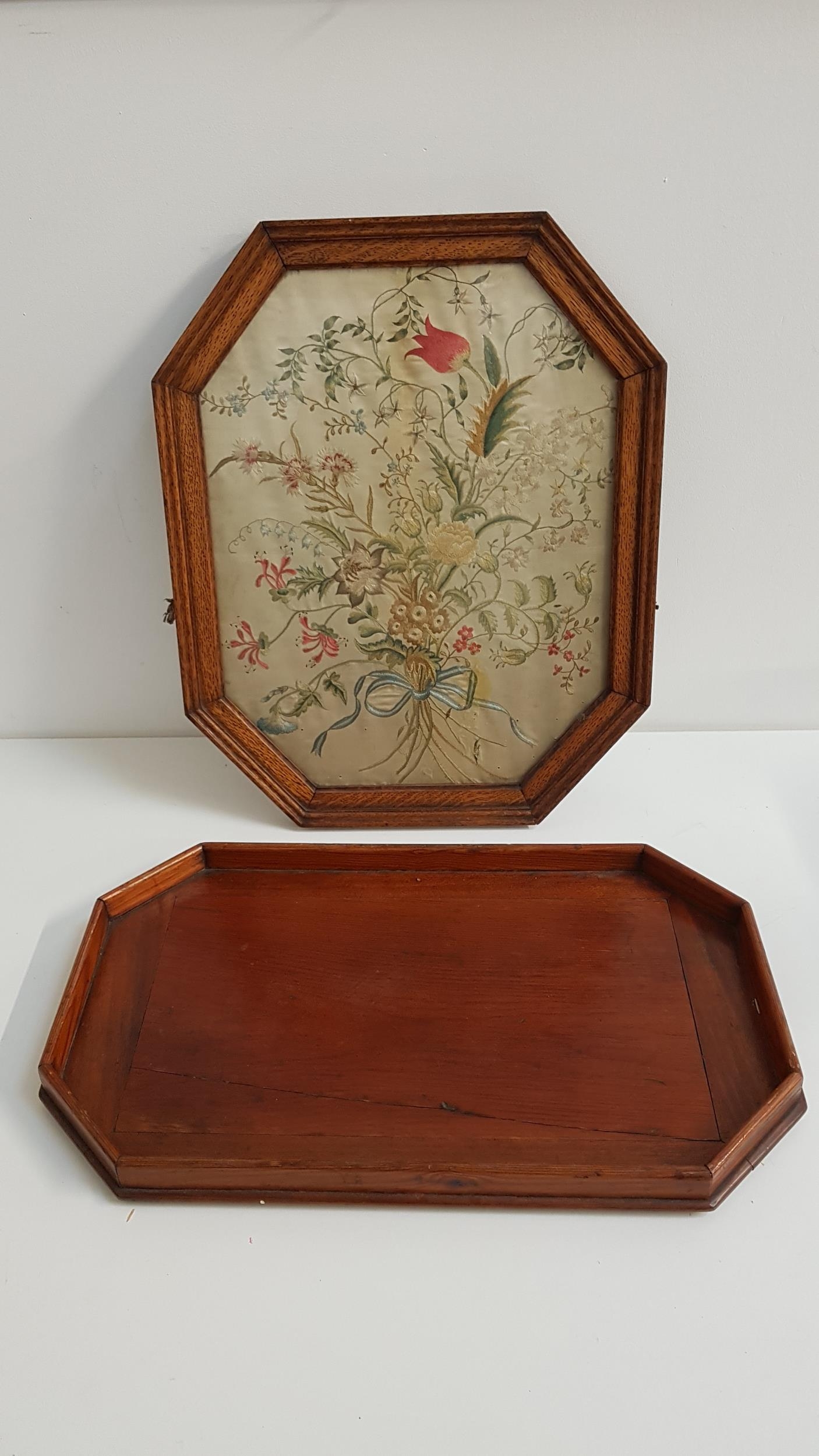 19th CENTURY SILK NEEDLEWORK PICTURE depicting floral sprays, in an octagonal oak frame, 50.5cm