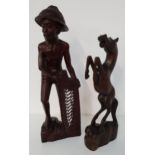 TWO CARVED INDONESIAN TEAK FIGURES one a rearing horse, 50cm high the other a fisherman with his