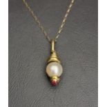 PEARL AND RUBY SET PENDANT in eighteen carat gold and on nine carat gold chain, the pendant 3cm long