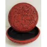 EARLY 20th CENTURY CHINESE CINNABAR BOWL and cover, profusely decorated with two five clawed dragons