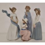 FOUR NAO FIGURINES including a young girl praying, 27.5cm high, a girl in a billowing gown, 25cm