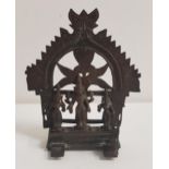 INDIAN BRONZE SHRINE with an arched top above Shiva, flanked by attendants on an oblong stepped base