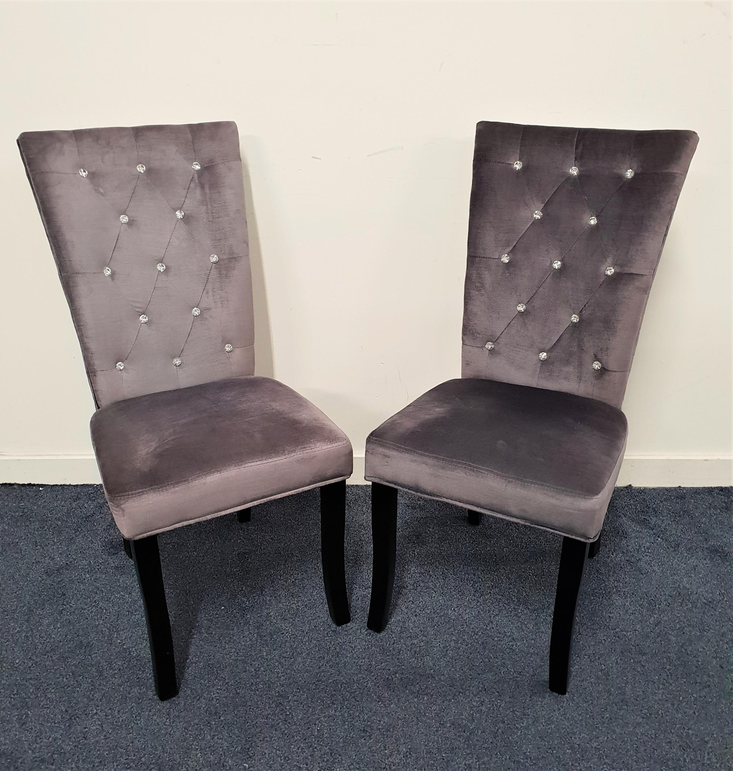 PAIR OF SIDE CHAIRS covered in a grey velvet with a crystal button backs, standing on shaped front