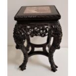 CHINESE HARDWOOD STAND with a square top inset with pink marble, above a pierced carved frieze,