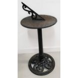 CAST IRON SUNDIAL with a circular top with Roman numerals on a tapering column and a circular