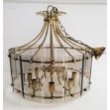 MODERN GILT BRASS CHANDELIER with smoked glass bevelled panels around eight shaped arms, with