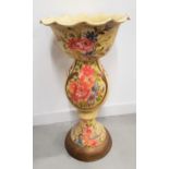 POTTERY JARDINERE AND STAND with a wavy rim and a shaped bulbous stand, decorated with flowers, 71cm