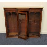 VICTORIAN MAHOGANY BREAKFRONT BOOKCASE with a central glass door flanked by a pair of glass panelled