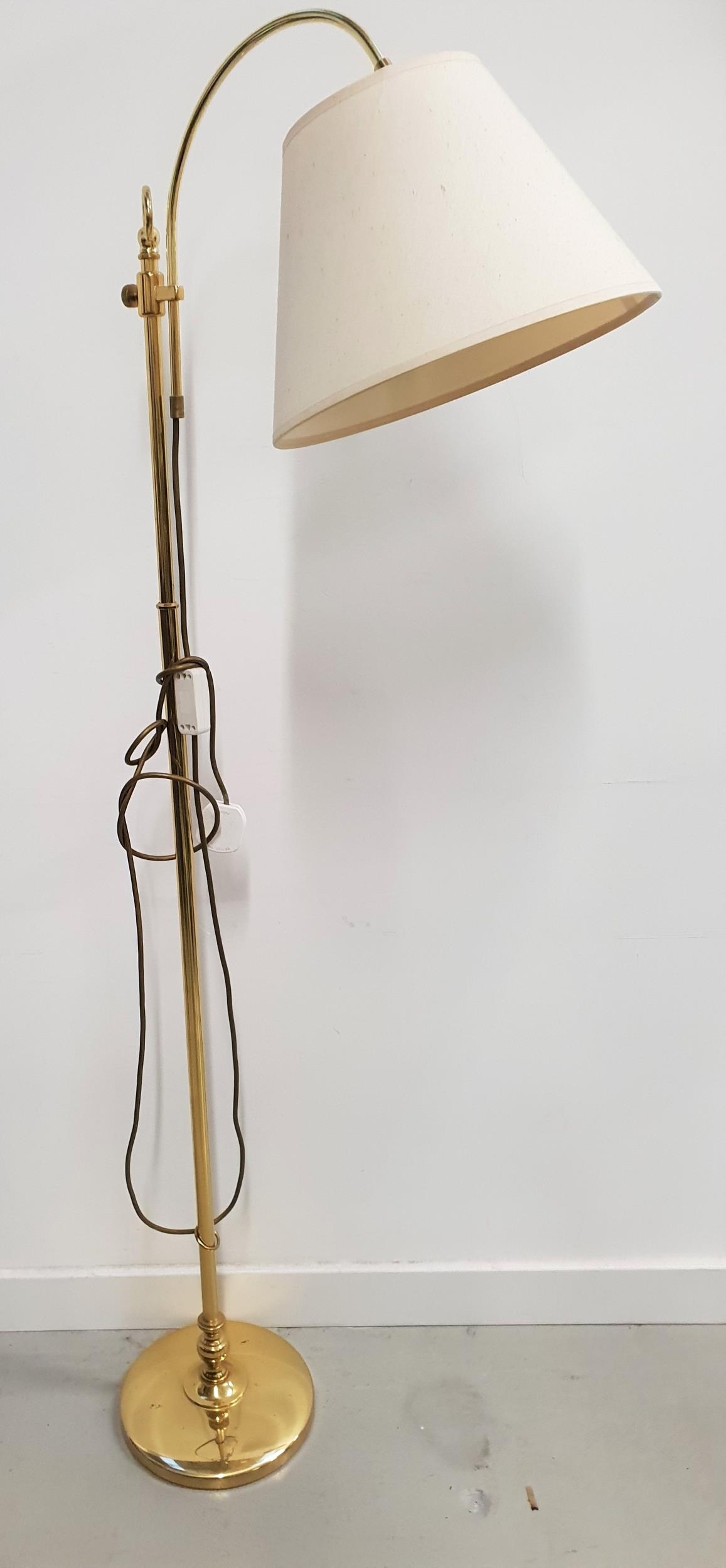 BRASS STANDARD LAMP raised on a circular base with a turned column and a shaped and height