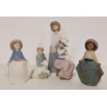 FOUR NAO FIGURINES including a girl in a long skirt and hat, 24cm high, girl seated holding a puppy,